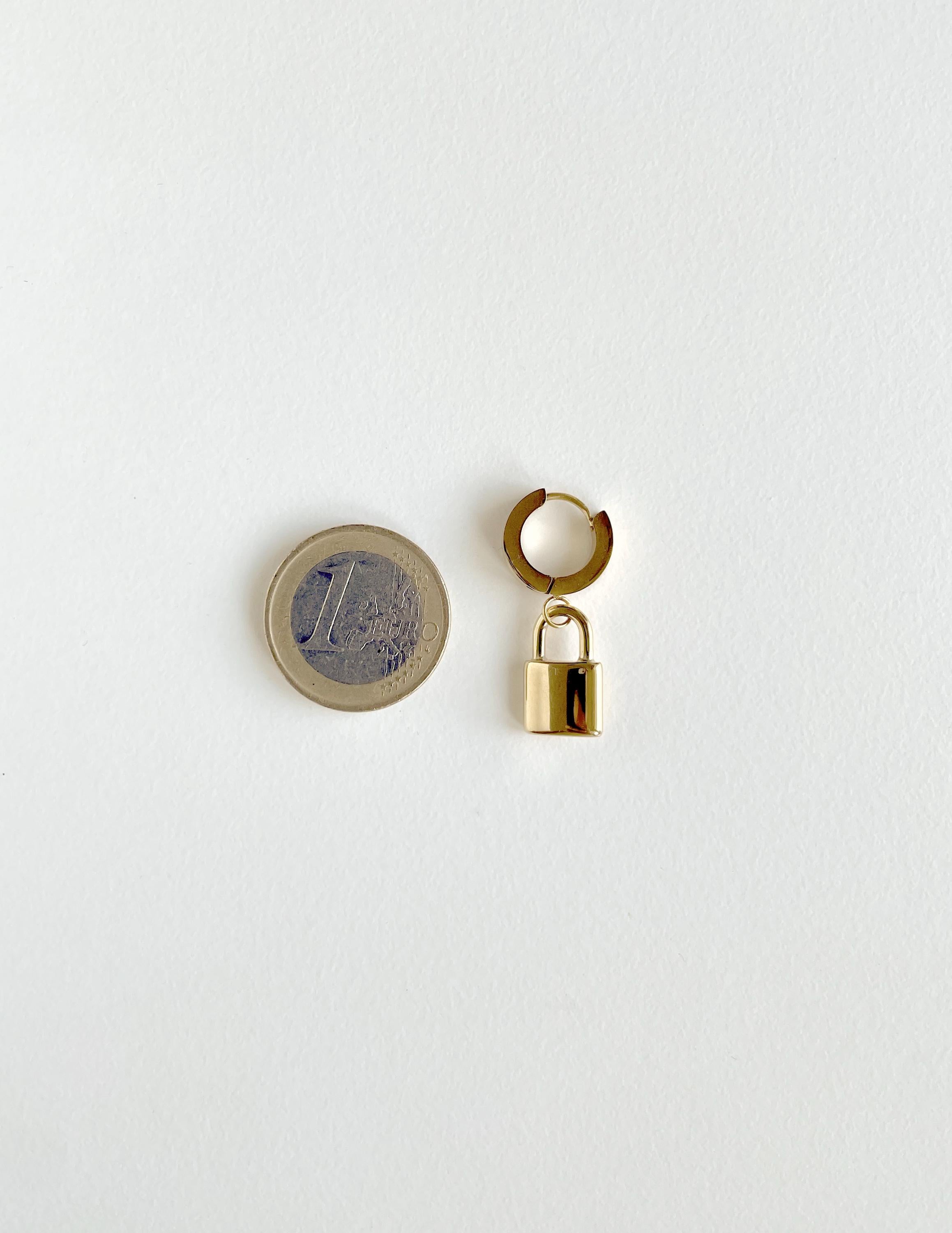 one padlock earring/huggie hoop in golden with a 1 euro coin for scale