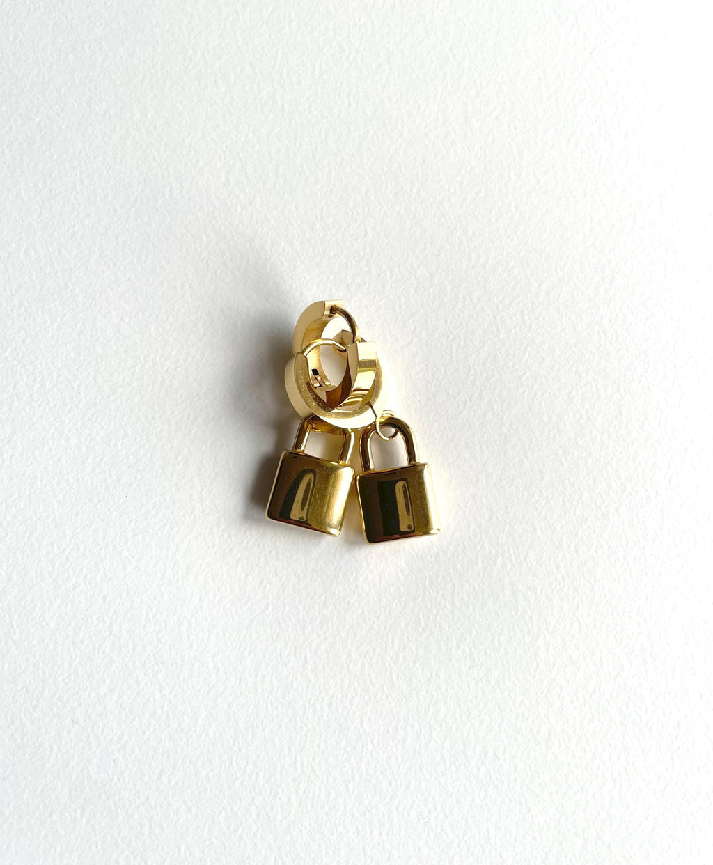 Gold Padlock Huggie Hoops on a white background