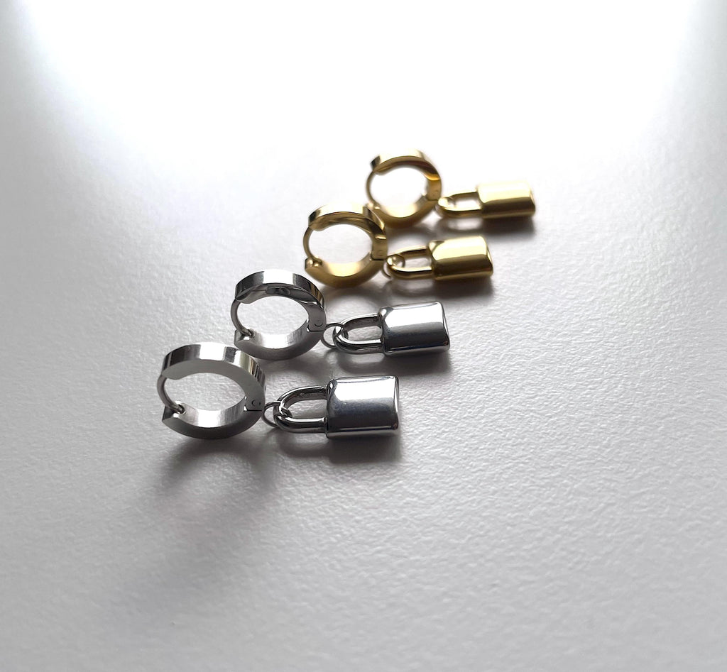 2 pairs of silver and gold padlock earrings against a white background