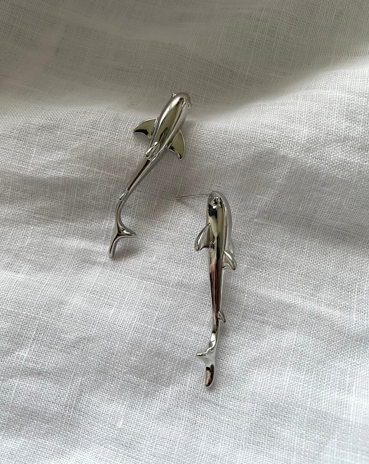 A pair of waterproof earrings, fish shaped made of brass plated with platinum, silver earrings